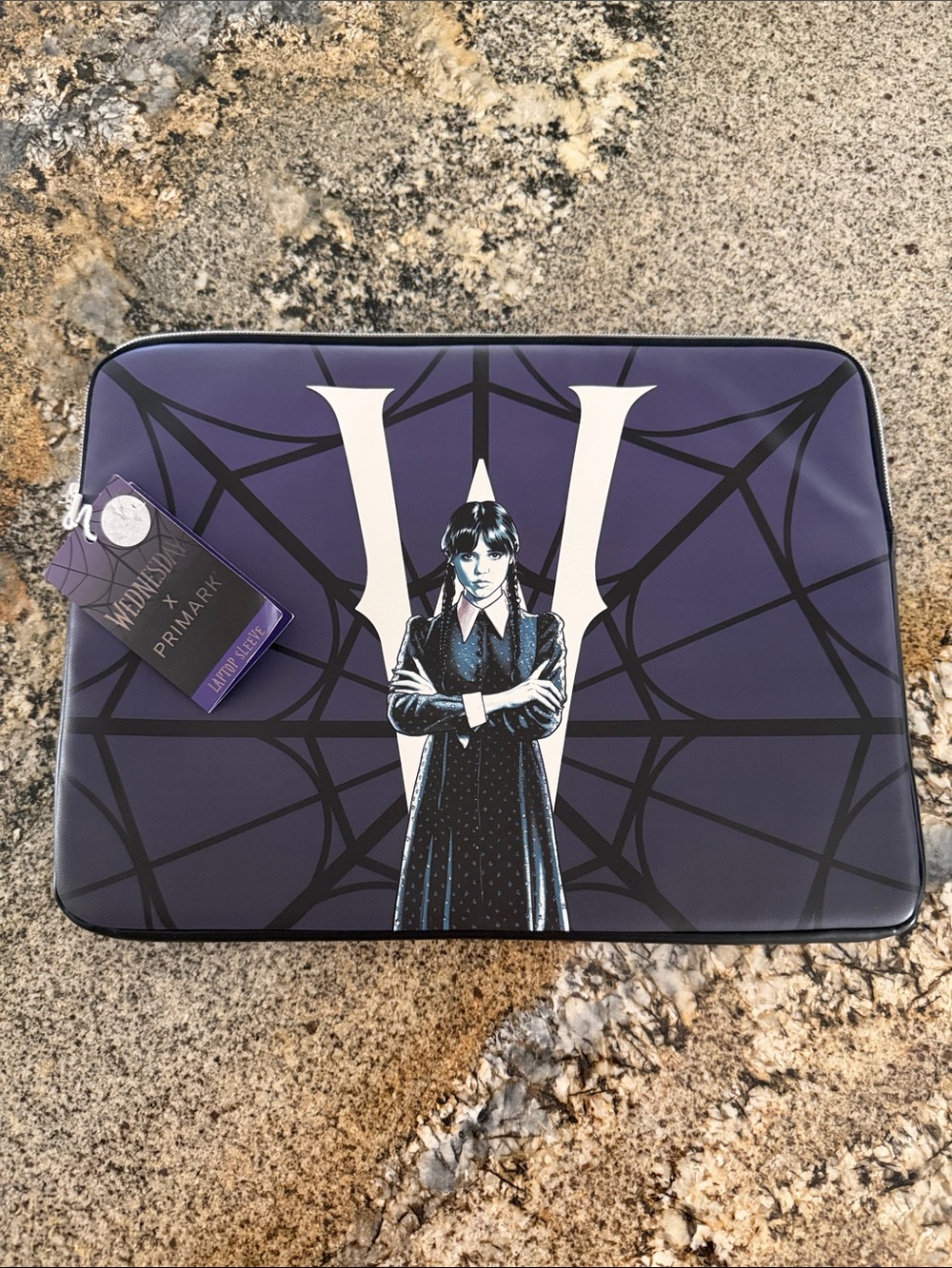 Wednesday Addams x Primark laptop sleeve featuring an illustration of Wednesday
